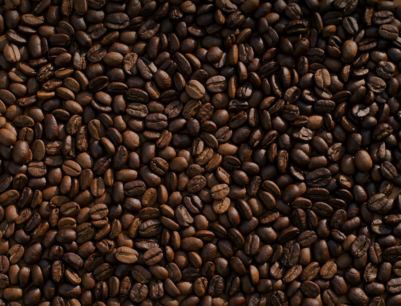 A dark espresso extraction streaming into a white cup on a chrome machine.
